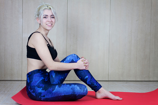 Portrait of beautiful young woman relaxing after doing exercise
