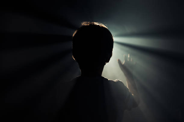 Prayer Silhouette of little boy looking to the light religion sunbeam one person children only stock pictures, royalty-free photos & images