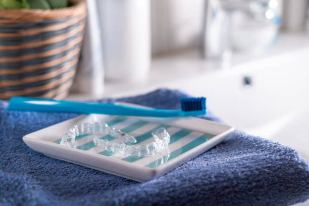 istock Transparent dental aligner and a blue toothbrush. 1518648295