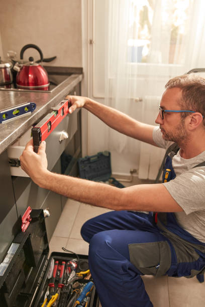 istock Handyman fixing kitchen cabinets in the apartment. 1518656640