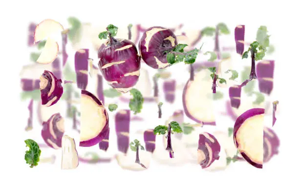 Abstract background made of Kohlrabi vegetable pieces, slices and leaves isolated on white.