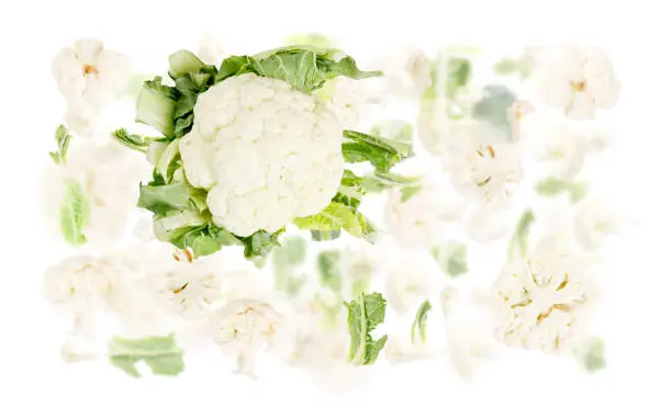 Abstract background made of Cauliflower vegetable pieces, slices and leaves isolated on white.