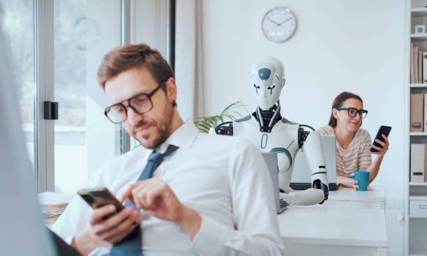 Efficient AI robot working and lazy employees Efficient AI robot working in the office and lazy inefficient employees chatting with their smartphones dumb-robot stock pictures, royalty-free photos & images