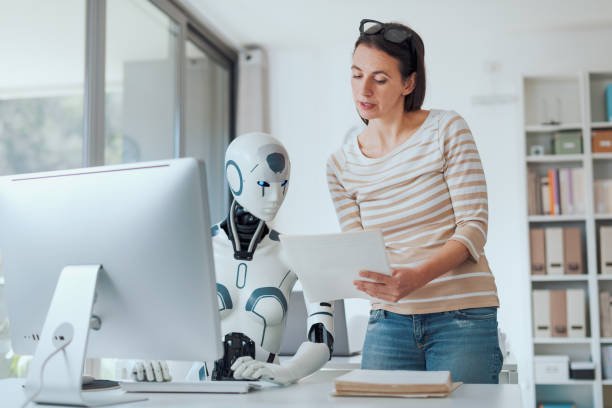 istock Woman and AI robot working together 1518667639