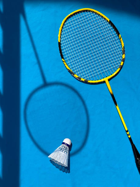 istock Rackets and badminton shuttlecock on a bright sunny day. View from above, drawing shadows 1518681937