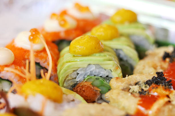 istock Closeup avocado sushi roll with pumpkin sauce 1518700598