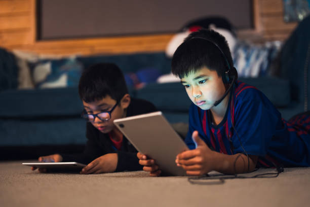 istock Kids playing games on device at home. 1518717336