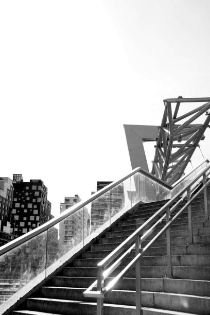 Stairway of a modern footbridge in Oslo. Ultra modern design with modern archtecture in the background.