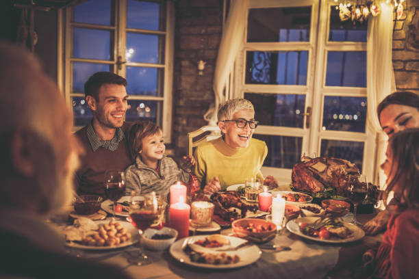 istock Happy multi-generation family enjoying in conversation during Thanksgiving dinner at dining table. 1518770903