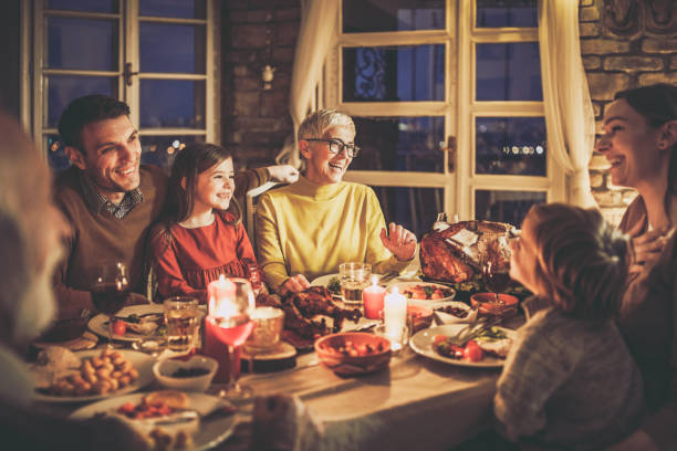 istock Happy extended family talking during Thanksgiving dinner at home. 1518774606