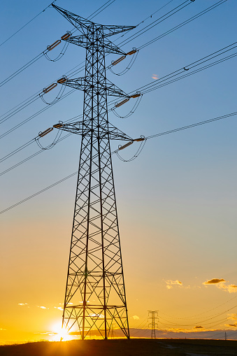 Power lines at sunset. Energy industry. Electricity transmission. Renewable production