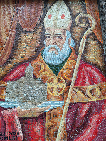 A mosaic depicting Saint Fructuosus casted into a rock at San Fruttuoso beach. Camogli. Genova. Italy.