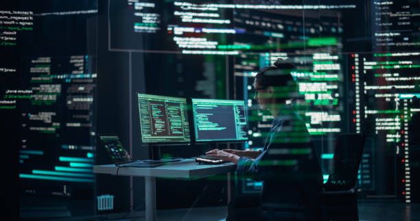 istock Female Programmer Working in Monitoring Control Room, Surrounded by Big Screens Displaying Lines of Programming Language Code. Portrait of Woman Creating a Software. Abstract Futuristic Coding Concept 1518850545