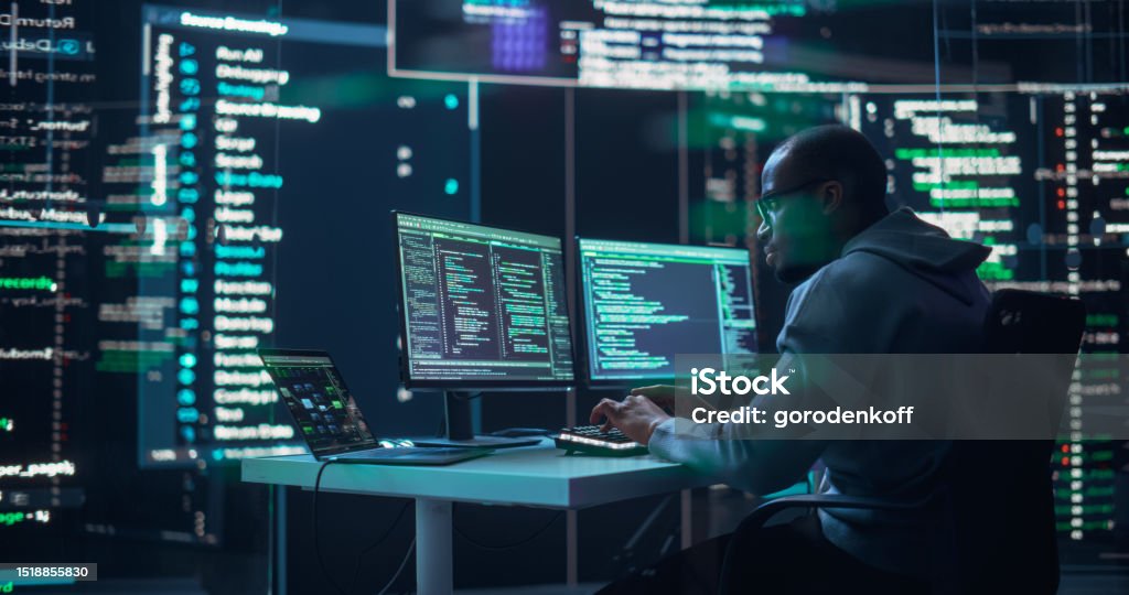 Black Male Developer Typing On Computer Surrounded By Transparent ...