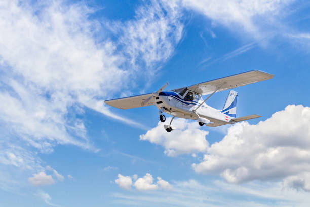 istock Light aircraft flying over blue sky 1518879825