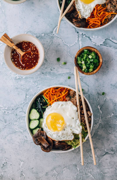istock Spicy Korean salad Bibimbap with rice, egg, beef and vegetables. 1518885730