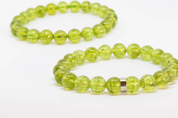 istock Peridot bracelet, power gemstone, on white background 1518903357