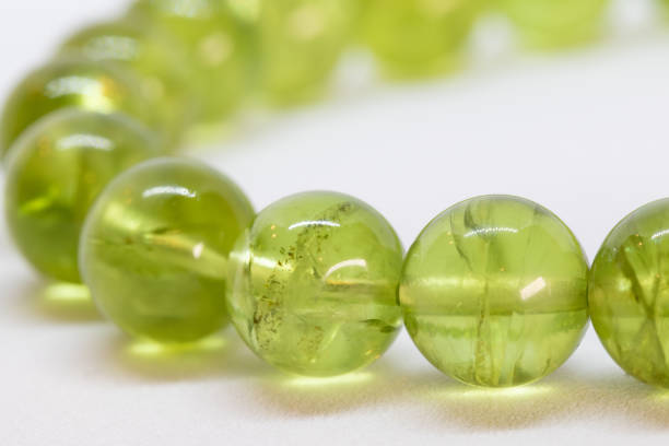 Bracelet of Peridot beads, one of the power gemstones, close-up shot on white background