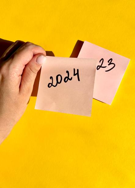 istock New Year 2024 written on note paper on a bright yellow background. 1518914005