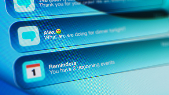 Applications on a smartphone, with notifications count in the corner. Stylised pixelated design to look like an extreme close-up on a mobile phone screen, with shallow depth of field.