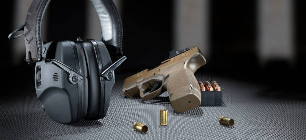 istock Headphones, pistol and ammo at the range 1518930895