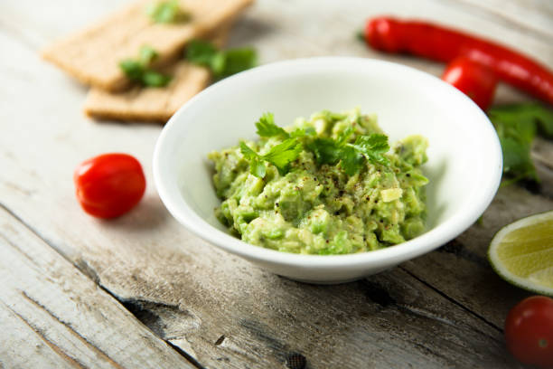 Mashed avocado Healthy mashed avocado with lime juice fresh cilantro stock pictures, royalty-free photos & images