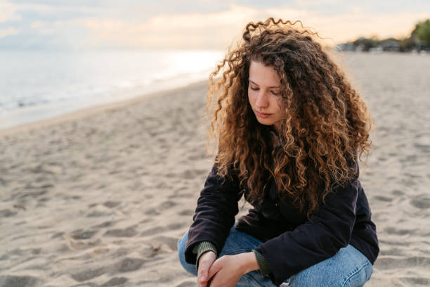 istock Sad Young Woman On The Beach In Greece 1518951256