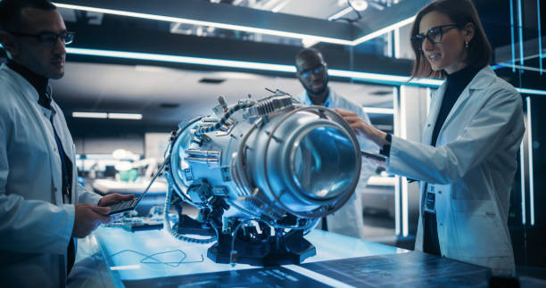 istock Portrait of a Young Team of Multicultural Engineers with Tablet and Laptop Computers, Analyze and Discuss How Electric Turbine Motor Works. High Tech Research Laboratory with Advanced Equipment 1518973889