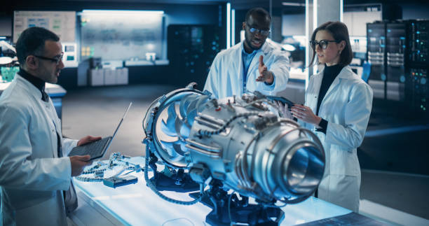 istock Airplane Engine Engineer and Scientist Work on a Futuristic Turbine Motor, Standing with Tablet Computer in Scientific Technology Lab. Professional Team Developing an Innovative Prototype Jet Engine 1518974777