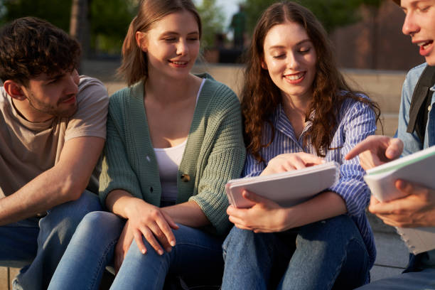 istock Group of caucasian students studying outside the university campus in sunset 1518975449