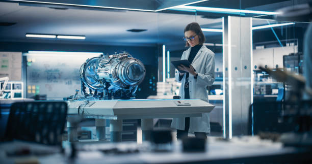 istock Industrial Engineer Working on a Futuristic Jet Engine, Standing with Tablet Computer in Scientific Technology Lab. Female Scientist Developing New Electric Motor in a Research Facility 1518976512