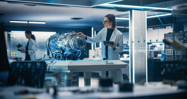 istock Industrial Engineer Working on a Futuristic Jet Engine, Standing with Tablet Computer in Scientific Technology Lab. Female Scientist Developing a New Electric Motor in a Research Facility 1518978766