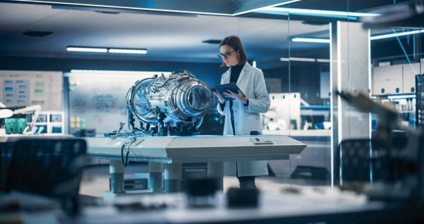 istock Industrial Engineer Working on a Futuristic Jet Engine, Standing with Tablet Computer in Scientific Technology Lab. Female Scientist Developing New Electric Motor in Advanced Research Facility 1519000129