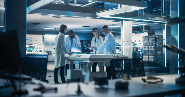 istock Team of Industrial Engineers Working on a Bionic Robot Arm at a Startup Factory. Multiethnic Male and Female Scientists Having a Conversation About an Electronic Component for a Humanoid AI Robot 1519001443