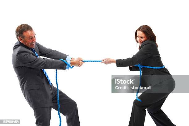 Mature Couple Isolated On White Background Playing Tug Of War Stock Photo - Download Image Now