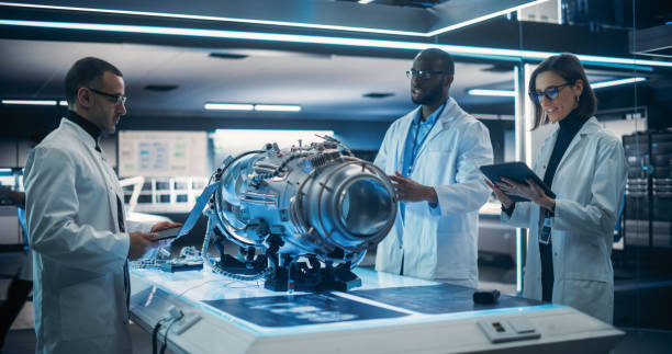 istock Portrait of a Young Team of Multicultural Engineers with Tablet and Laptop Computers, Analyze and Discuss How a Modern Electric Turbine Motor Works. High Tech Research Laboratory with Modern Equipment 1519007925