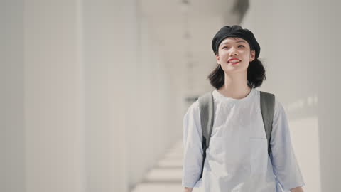 Asian Chinese young woman walking in corridor sidewalk Penang old town street during day time