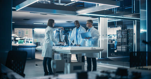 istock Young Team of Smart Diverse Multicultural Engineers Building and Developing a Robot Dog Concept. High Tech Research Factory with Talented Professional Employees 1519041975