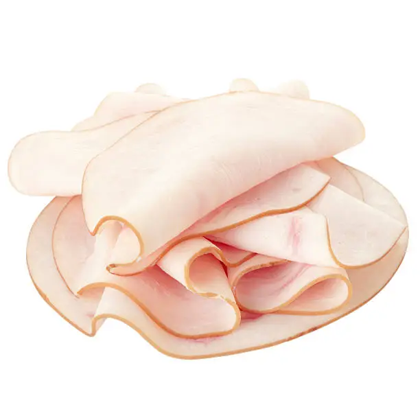 Photo of Freshly sliced stack of turkey breast on a white background