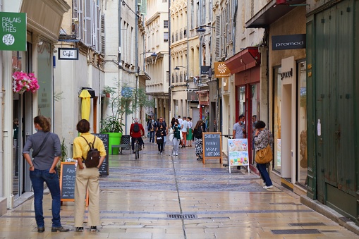 People walk in downtown Avignon, France. Historic centre of Avignon is a UNESCO World Heritage Site.