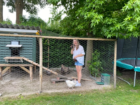 Senior woman takes care of the Chickens