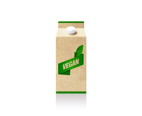 Vegan symbol printed milk package which is made of recycled paper on white background.