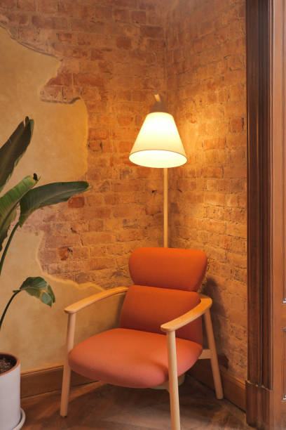 istock a lamp and a chair at home against brick wall 1519078295