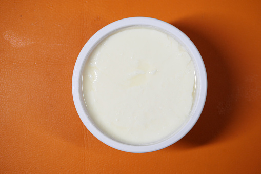 fresh yogurt in a bowl on table .
