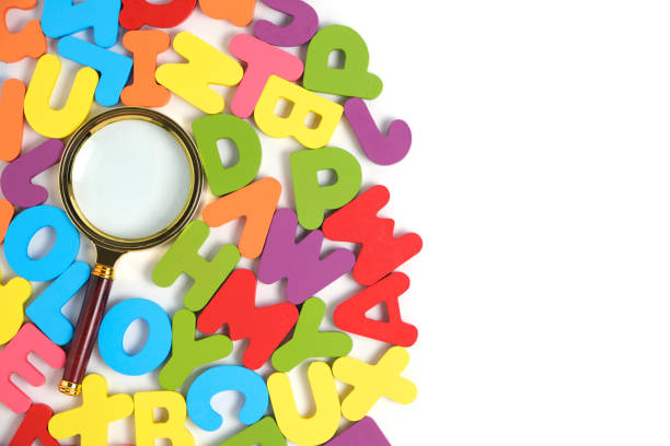 istock Magnifying glass and bright multicolored letters English alphabet white background. 1519081502