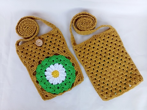 Crochet bag handmade daisy flowers background texture