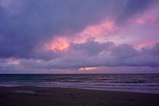 istock Dramatic sky before the storm. Purple sky before the storm. Pink sunset in Denmark. Tragic sky in front of a storm on a Danish beach. 1519112073