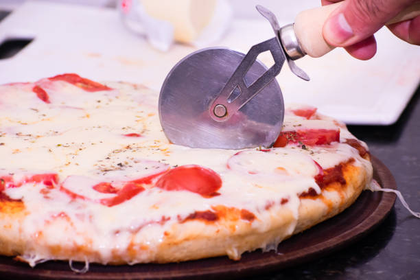 istock Slice and Dice: Mature Man Expertly Cutting Homemade Mozzarella Pizza 1519143810