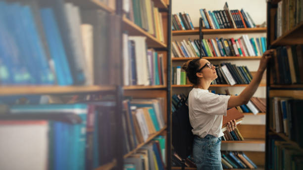 istock A student stuying and reading books in a public library. 1519148109