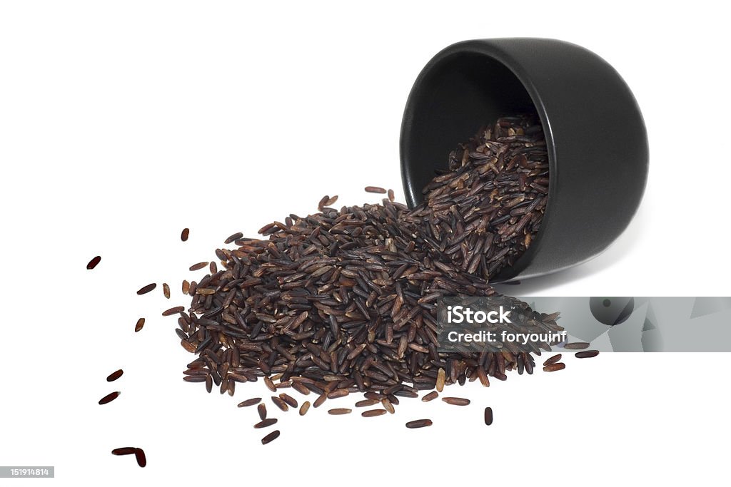 brown rice Wild brown rice in  bowl and loose over white background Black Color Stock Photo